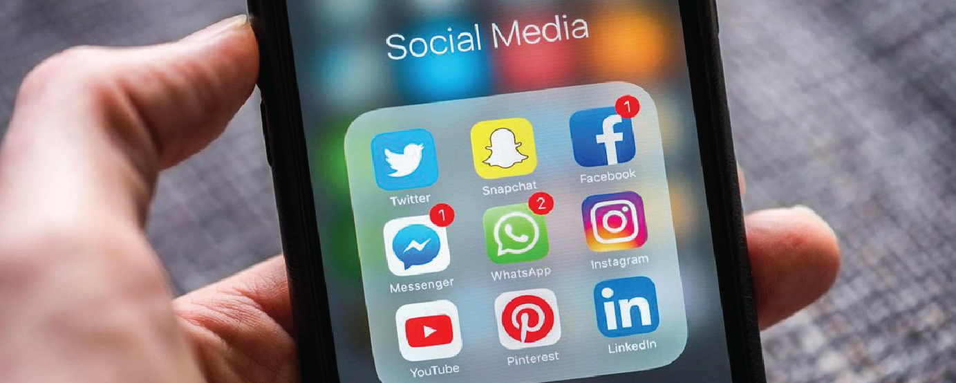 person holding phone showing social media apps