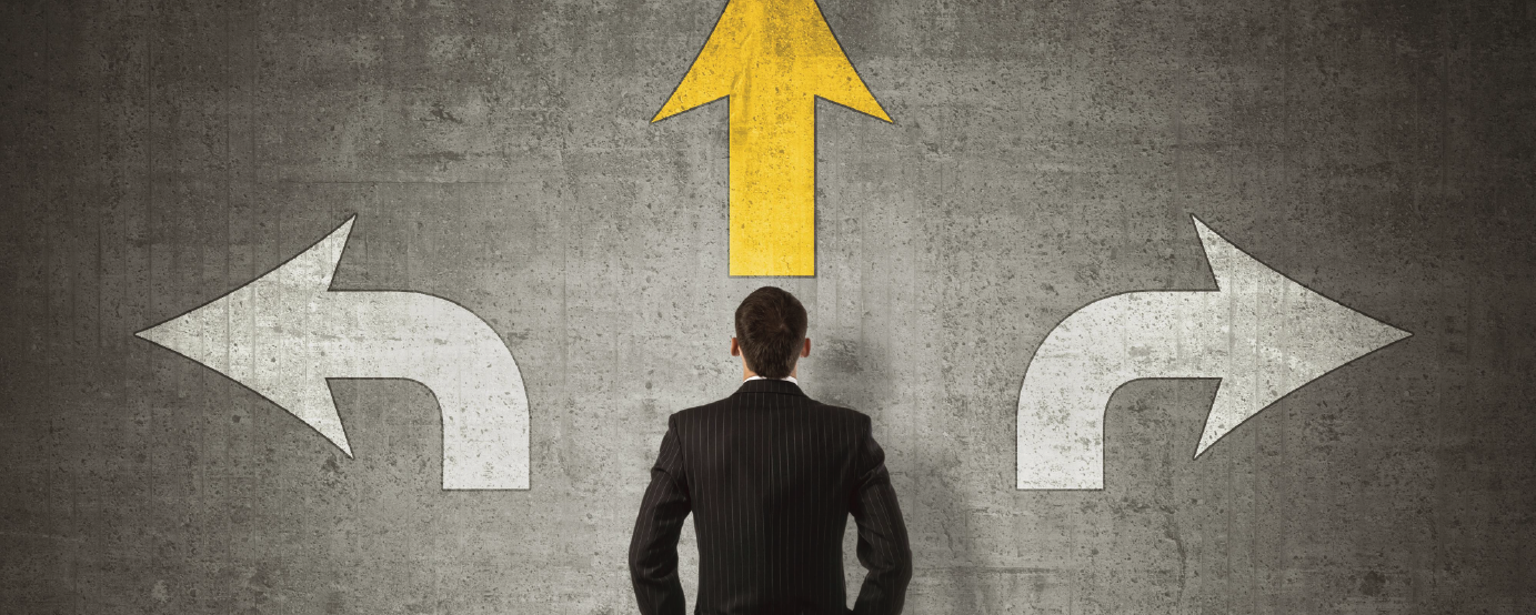 Man facing a wall with three arrows one pointing left one straight and the other pointing to the right