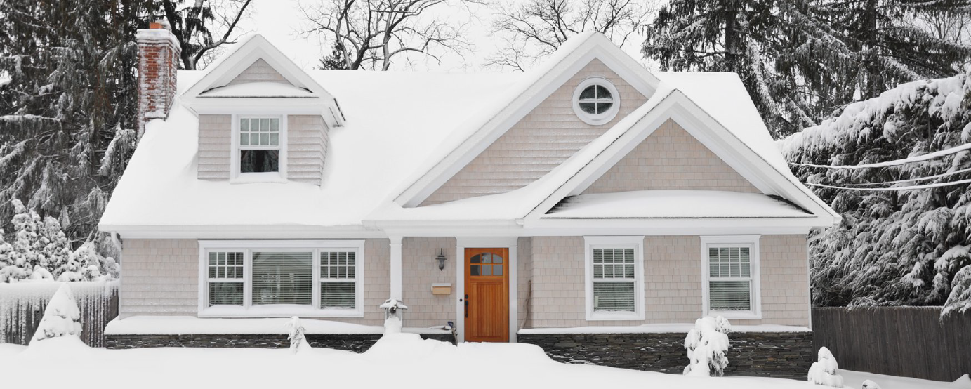 snow covered home sits back off street