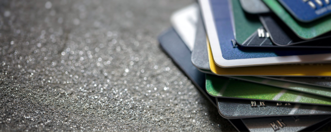 Photo shows a stack of credit cards from different places