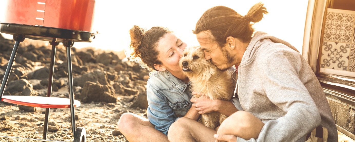 Hipster couple and cute dog relaxing by old time mini van