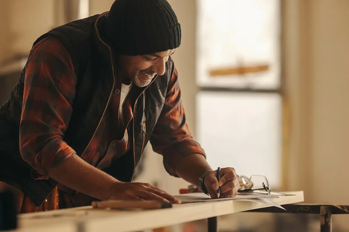 A contractor checks paperwork on a job sight.