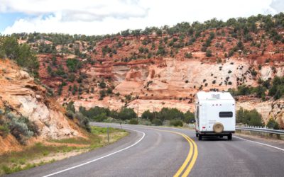 Picture of RV driving thru canyon.