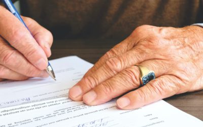 Picture showing hands signing a document.