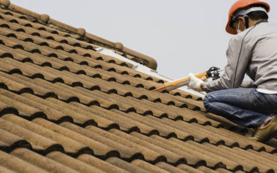 Picture of roofer installing concrete tiles.